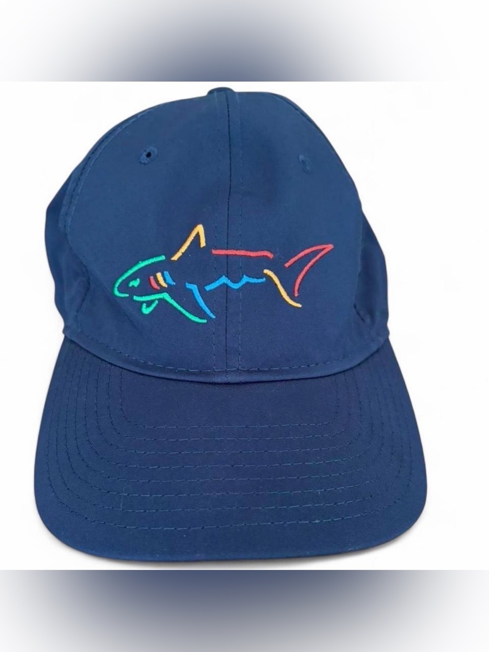 Greg Norman Collection Navy Cap with Multicolor Shark Logo. Adjustable fit.